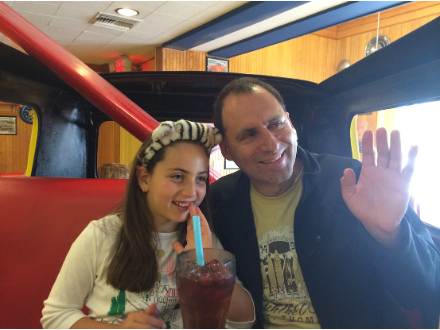 Emily Judith Mitnick enjoying breakfast at her favorite restaurant. She is smiling and happy.